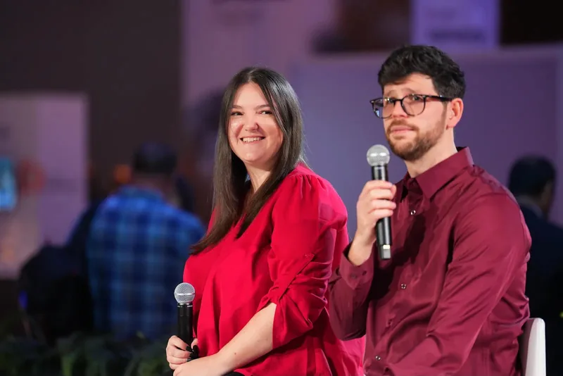 Lorena Lovric smiling beside a fellow panellist during a conference session